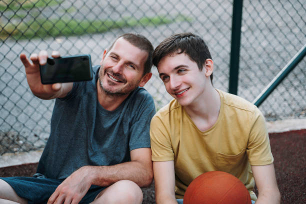istock Morning Training. Father And Son Playing Basketball. Conversation between father and a son 1616986032