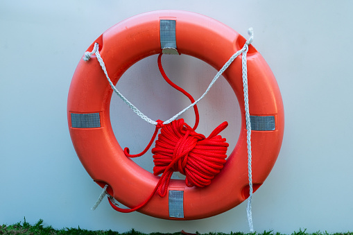 Orange lifebuoy on old sailing ship