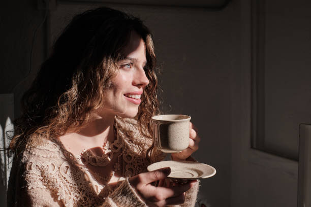 istock Young woman with cup of coffee 1616990369