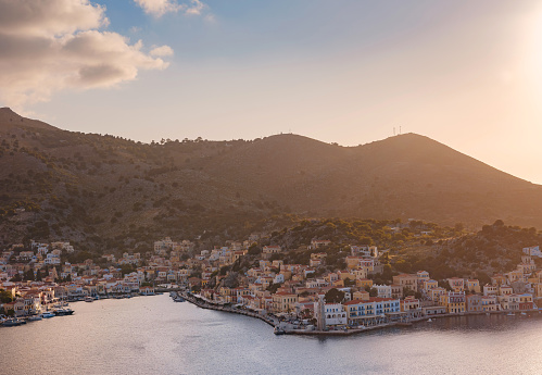 Symi Island, Greece. Greece islands holidays from Rhodos in Aegean Sea. Colorful neoclassical houses in bay of Symi. view of main bay of island, where tourist ferries and yachts moor