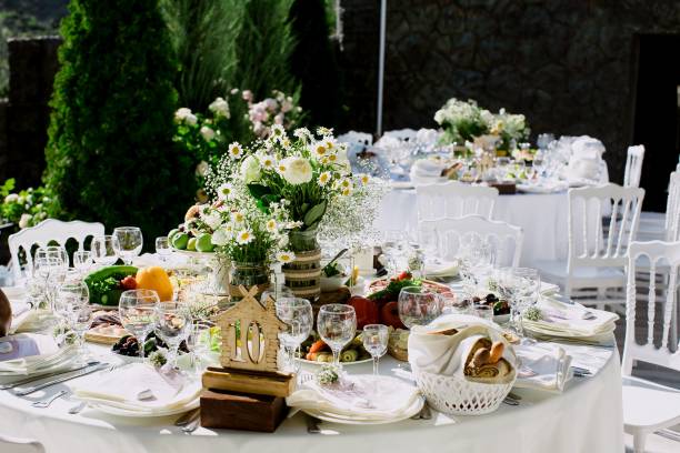 istock Elegantly set table with delicate wedding floral centerpieces and shining glassware 1617008381