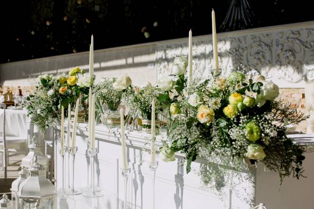 istock Elegantly set table with delicate wedding floral centerpieces and shining glassware 1617008384