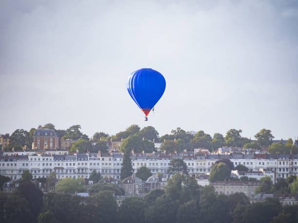 istock Blue hot air balloon flying over Bristol 1617043469