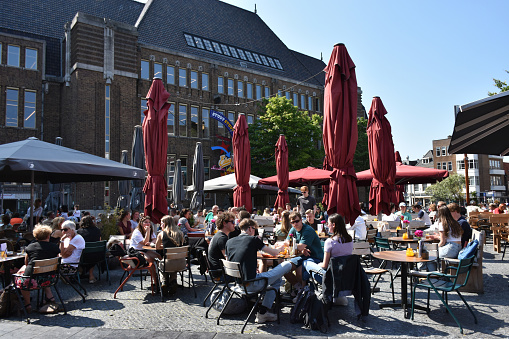 Utrecht, The Netherlands - June 8, 2023: Scene Of Building Exterior, People Walking, Sitting Down, Talking To One Another, Eating And Drinking In A Restaurant During Summertime