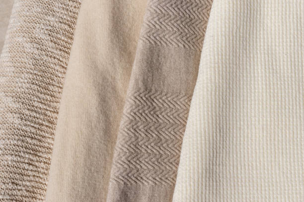 istock Beige, taupe, light brown, creamy wool, cotton and cashmere blend knitted sweaters texture stack together. Warm neutral color autumn clothes, knitwear wardrobe concept 1617056925