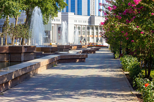 Dushanbe, Tajikistan - August 12, 2022: Central Rudaki Avenue and Park with fountains ans street view in summer.