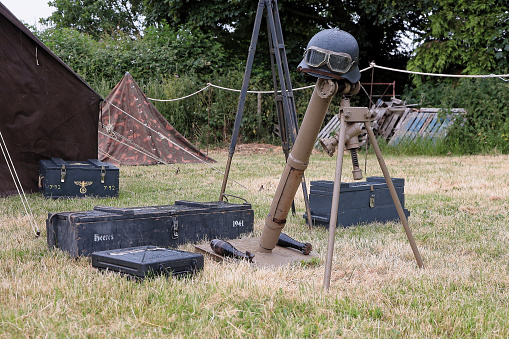 German Stahlhelm, goggles and mortar, ww2 era. Part of a reenactment German camp. —- Second World War, Home Front, Home Guard and other 1940s paraphernalia all on display at Ashby Parva Vintage Revival - Ashby Parva, Leicestershire, 17th June 2023