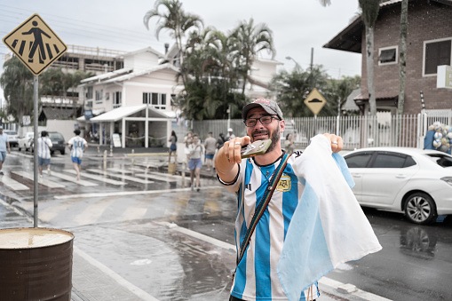 Canasvieiras Florianopolis Brazil - December 18, 2022: The young man is very excited and sentimental about the triumph of the Argentina national soccer team.