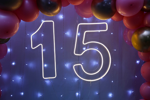 number fifteen with lights at 15th birthday party - front view - light party