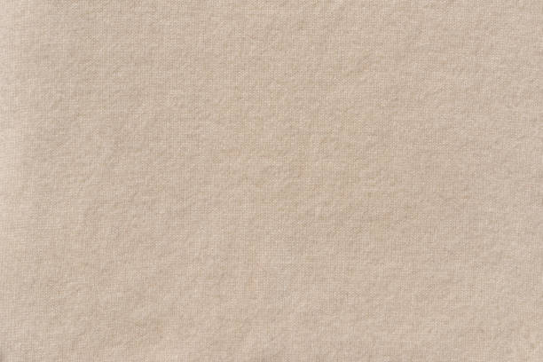 istock Neutral beige woolen knitted jersey cloth soft texture background. Minimalist autumn, winter cozy backdrop, copy space 1617084693