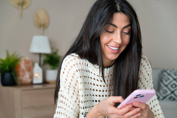 istock Woman using smart phone at home 1617093425