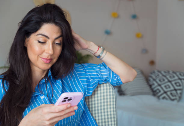 istock Sad Woman  using her phone at home 1617097132