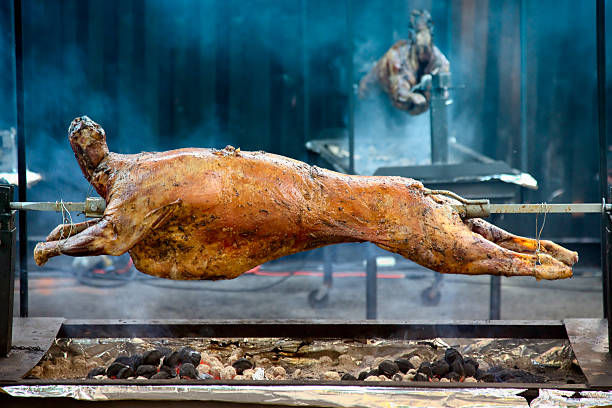 Whole lamb barbecue spitfire roast over hot coals.