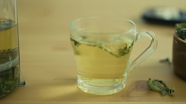 green tea mug over wooden table