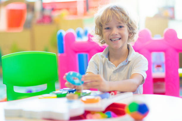 istock Little boy in with toys in school classroom. 1617149554