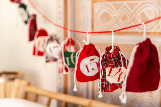 Traditional advent calendar hanging in cozy living room stock photo