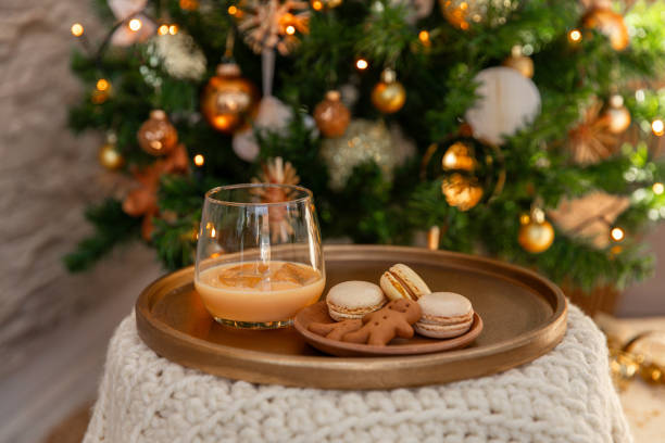 Eggnog Cream liqueur on festive Christmas table with cookies and decorations stock photo