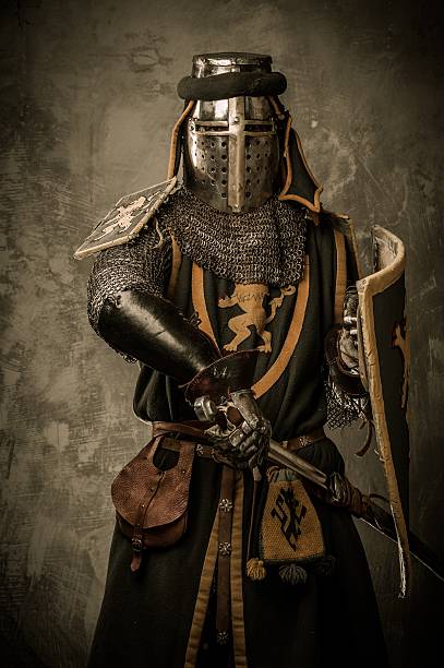 istock Medieval knight with sword and shield against stone wall 161716845
