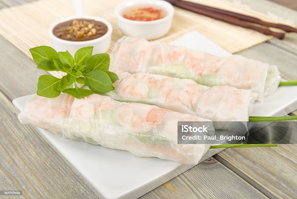 Goi Cuon Vietnamese fresh summer rolls filled with prawns, pork, herbs, rice vermicelli and vegetables served with hoisin and peanut dip and nouc mam cham. Appetizer Stock Photo