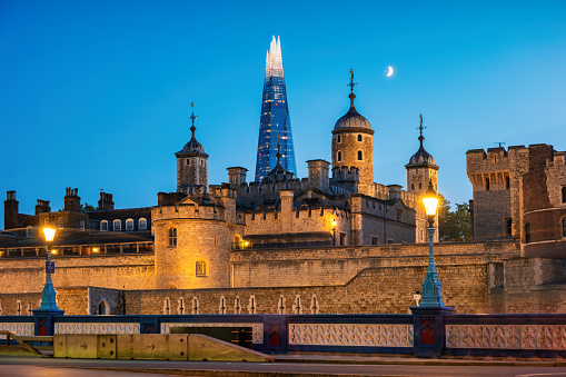 The Tower of London and The Shard skyscraper in London England UK in the evening.