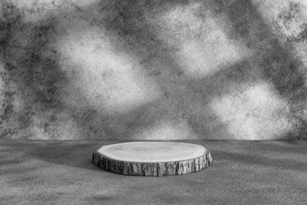 istock Wooden podium on a gray concrete background with shadows and window light. Side view. 1617183809