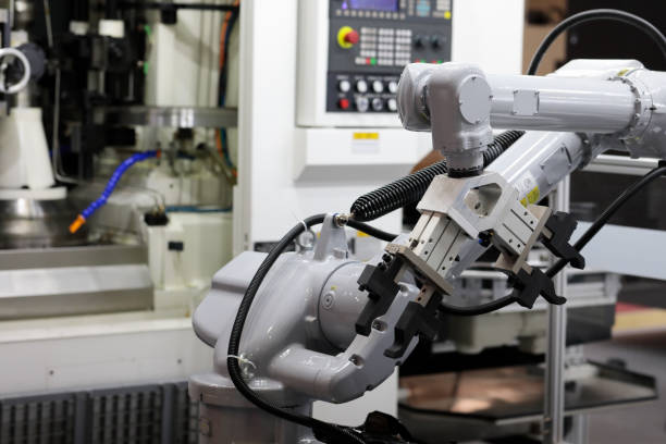 istock industrial robotic arm with CNC machining center 1617185944