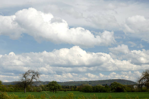 Cumulus beautiful clouds in blue sky, rural landscape in summer