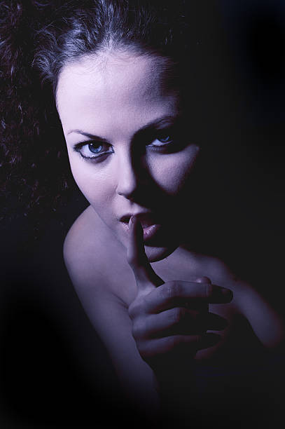 istock girl shows silence gesture 161721750