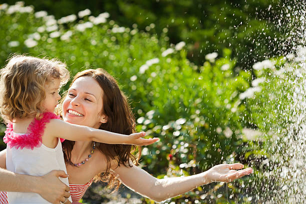 istock Woman with child playing in spring park 161721870