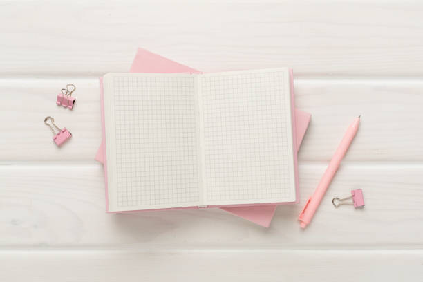 istock Open notebook with stationery on wooden background, top view 1617225252