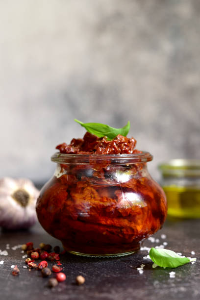 istock Pickled dried tomatoes in a vintage jar. 1617227887