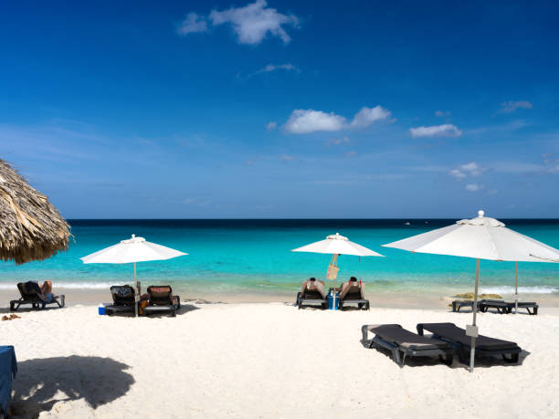 Lounge chairs and umbrellas on Kleine Knip / Playa Kenepa , beach, Curacao