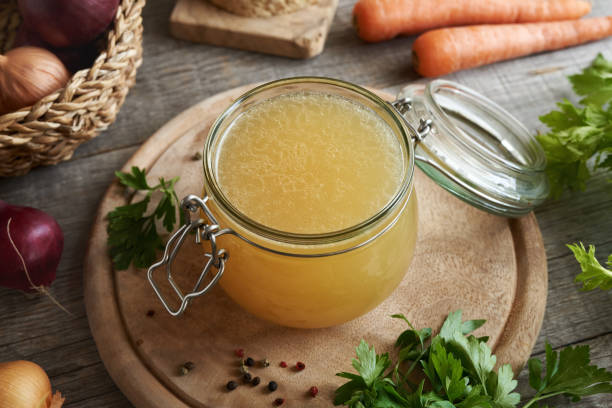 istock Bone broth in a glass jar with carrots, parsley and onion 1617235949