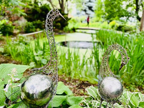 Garden art sculptures with pond in the background
