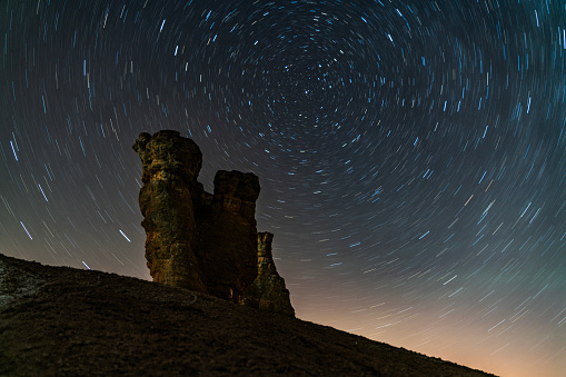 star exposure photo in dark valley located outside the city. In the dark, millions of stars and the Milky Way are visible in the sky. Taken with a full-frame camera using the long exposure technique.