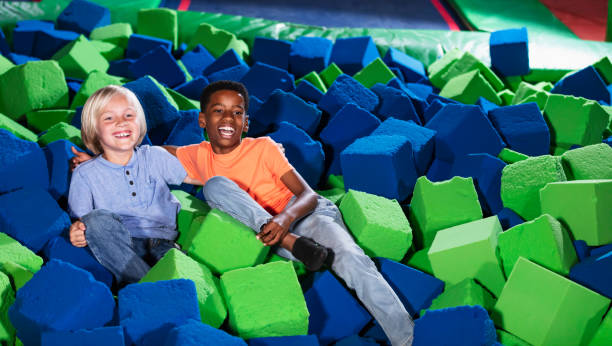 istock Two multiracial boys playing in a pool of foam blocks 1617244222