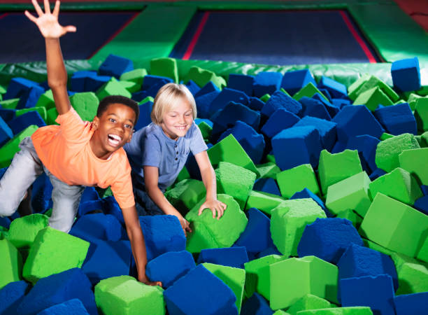 istock Two multiracial boys playing in a pool of foam blocks 1617244463