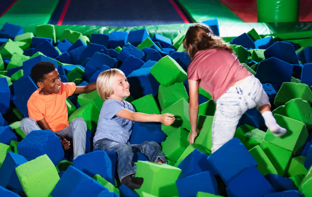 istock Three multiracial children play in pool of foam blocks 1617244496