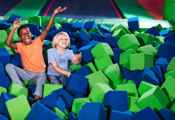 istock Two multiracial boys playing in a pool of foam blocks 1617244498