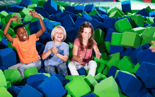 istock Three multiracial children play in pool of foam blocks 1617244525