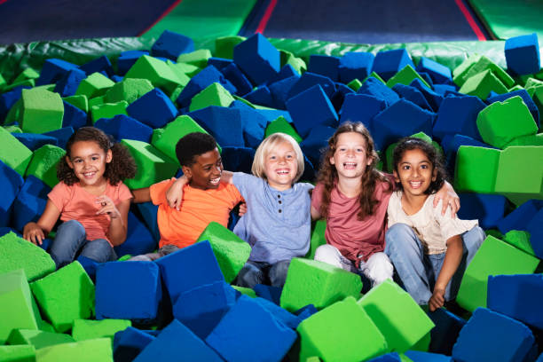 istock Five multiracial children play in pool of foam blocks 1617244537