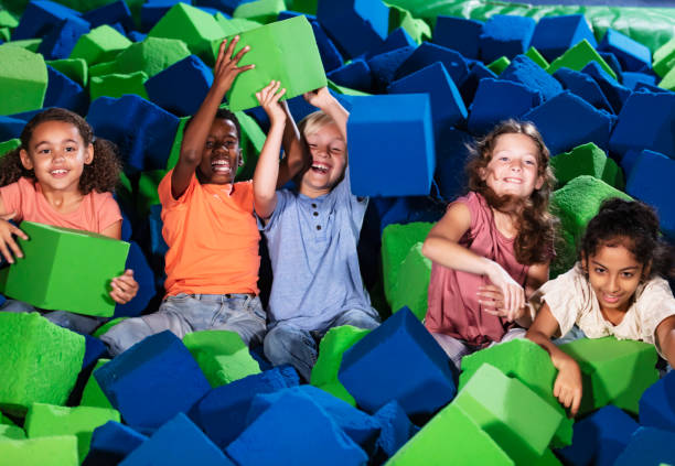 istock Five multiracial children play in pool of foam blocks 1617244546