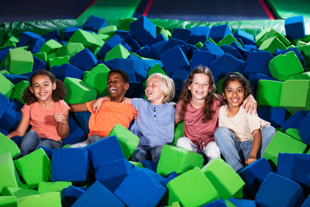 istock Five multiracial children play in pool of foam blocks 1617244548