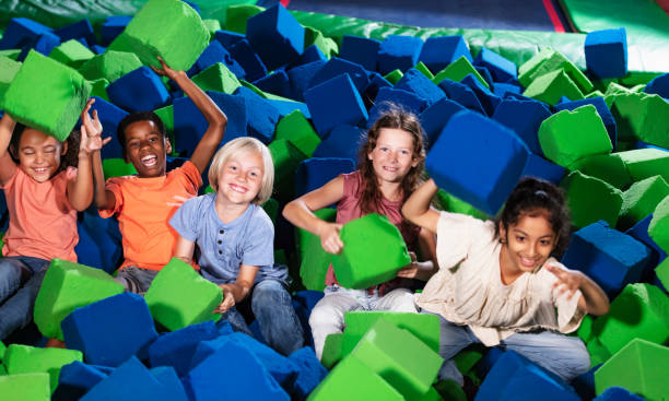 istock Five multiracial children play in pool of foam blocks 1617244568