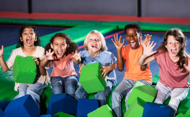 istock Five multiracial children posing by a pool of foam blocks 1617245118