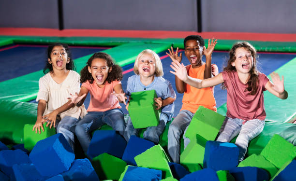 istock Five multiracial children posing by a pool of foam blocks 1617245126