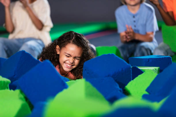 istock Girls having fun playing at indoor amusement center 1617245788