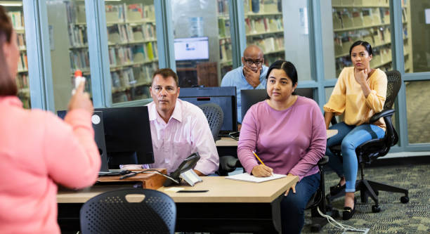 istock Adult students listening to instructor in class 1617248385