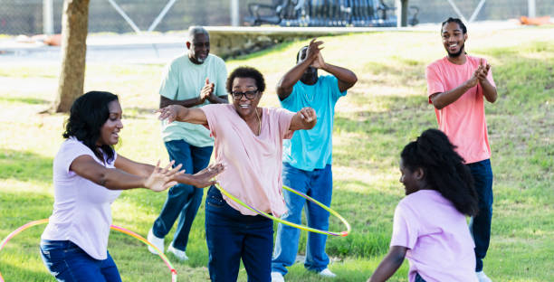 Multi-generation African-American family have fun hooping