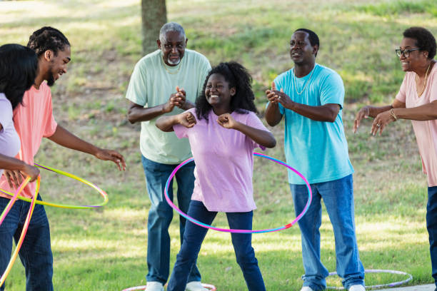 Multi-generation African-American family have fun hooping